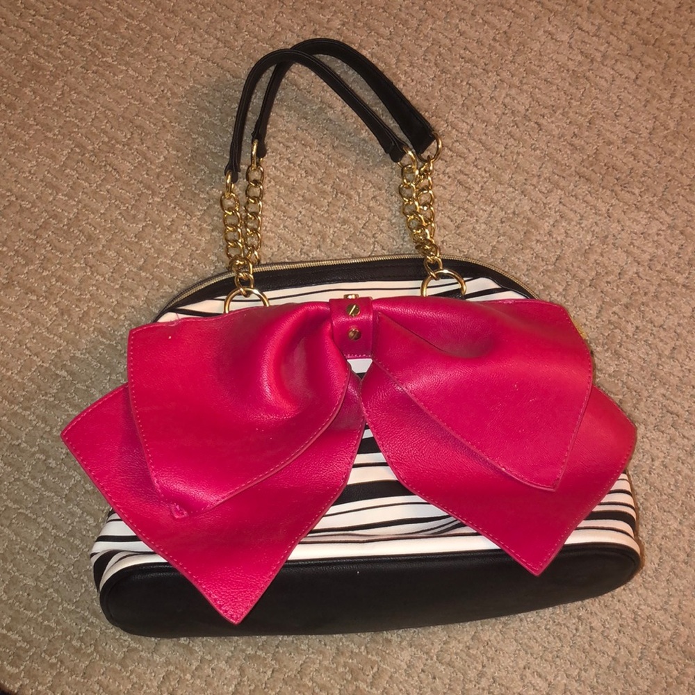 Betsy Johnson purse very roomy and cute. Barley used.